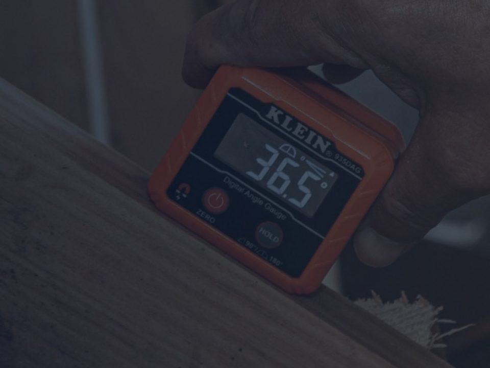 Man Using Digital Angle Gauge for Woodworking Project